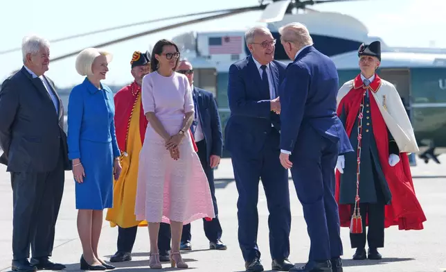 President Donald Trump is welcomed by H.E. Guy Parmelin, President of the Swiss Confederation, Ambassador Callista Gingrich U.S. Ambassador to Switzerland, Speaker Newt Gingrich, former Speaker of the U.S. House of Representatives and Ambassador Terrence Billeter, Head of Protocol of the Federal Department of Foreign Affairs, Switzerland, as he disembarks Air Force One at Geneva Airport, ahead of the G7 Summit in France, Monday, June 15, 2026, in Geneva, Switzerland. (AP Photo/Julia Demaree Nikhinson)