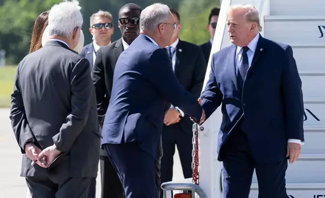 Swiss Federal President Guy Parmelin welcomes President Donald Trump, right, after Trump disembarked from Air Force One at Geneva Airport, Switzerland, prior the G7 summit, Monday, June 15, 2026. (Martial Trezzini/Pool Photo via AP)