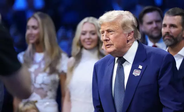 President Donald Trump attends the UFC Freedom 250 on the South Lawn of the White House, Sunday, June 14, 2026, in Washington with Lara Trump, Tiffany Trump and Donald Trump Jr. (AP Photo/Alex Brandon)