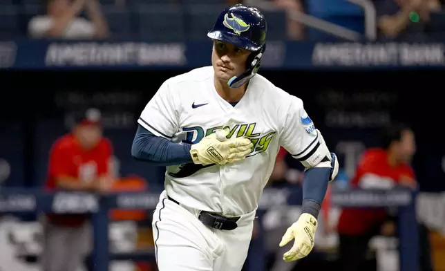 Tampa Bay Rays' Jonny DeLuca celebrates as he rounds the bases after his home run during the eighth inning of a baseball game against the Washington Nationals Friday, June 19, 2026, in St. Petersburg, Fla. (AP Photo/Jason Behnken)