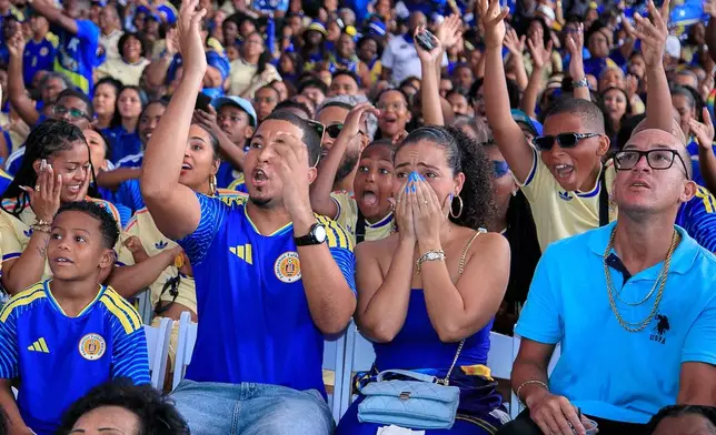 Curacao soccer fans watch their team's World Cup match against Germany, during a viewing party in Willemstad, Curacao, Sunday, June 14, 2026. (AP Photo/Endrymar Martis)