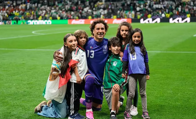 Mexico goalkeeper Guillermo Ochoa poses with children after a World Cup Group A soccer match between Mexico and Czechia in Mexico City, Wednesday, June 24, 2026. (AP Photo/Silvia Izquierdo)