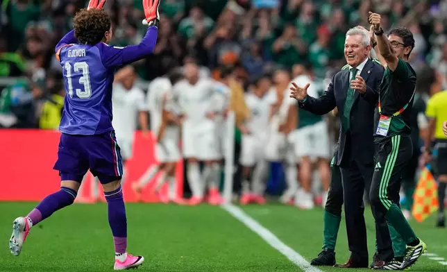 Mexico goalkeeper Guillermo Ochoa (13) runs to Mexico head coach Javier Aguirre after teammate Alvaro Fidalgo (8) scored their third goal the World Cup Group A soccer match between Czechia and Mexico in Mexico City, Wednesday, June 24, 2026. (AP Photo/Fernando Llano)
