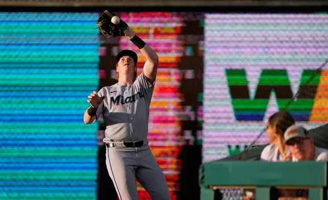 Miami Marlins right fielder Owen Caissie catches a fly out by Philadelphia Phillies' Edmundo Sosa during the third inning of a baseball game Monday, June 15, 2026, in Philadelphia. (AP Photo/Matt Slocum)