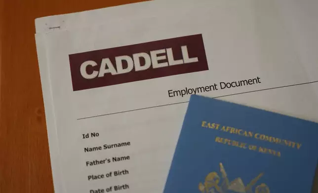 Employment documents and a passport belonging to a worker at the construction site of the new U.S. Consulate are seen in Milan, Italy, Monday, June 8, 2026, amid an investigation into alleged exploitative labor practices at the site. (AP Photo/Antonio Calanni)