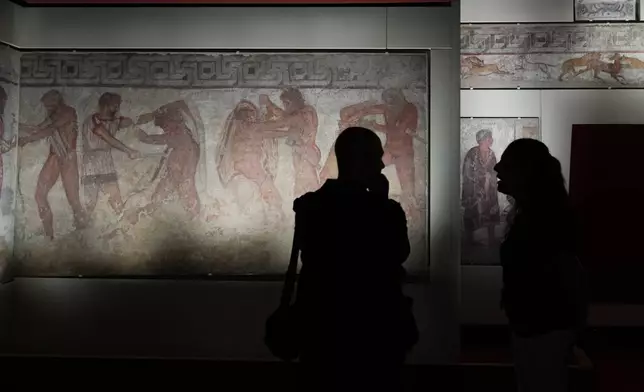 Reporters visit the frescoes, dating from 330–310 B.C., exhibited in the reconstruction of the François Tomb, an Etruscan tomb, at the Villa Giulia Etruscan Museum in Rome, Tuesday, June 30, 2026. (AP Photo/Alessandra Tarantino)