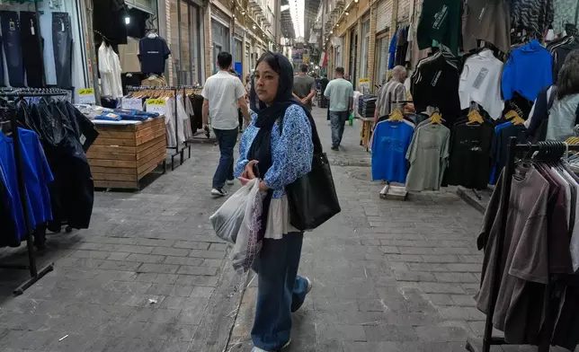 A woman walks at Tehran's historic Grand Bazaar, Iran, Monday, June 1, 2026. (AP Photo/Vahid Salemi)