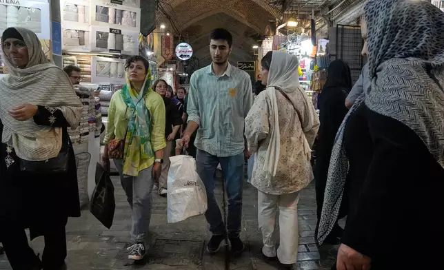 People walk at Tehran's historic Grand Bazaar, Iran, Monday, June 1, 2026. (AP Photo/Vahid Salemi)