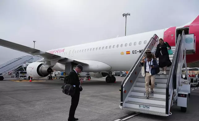 Journalists leave the papal flight after takeoff was delayed at Los Rodeos International Airport, at the Canary Islands, Spain, Friday, June 12, 2026. (AP Photo/Alessandra Tarantino)