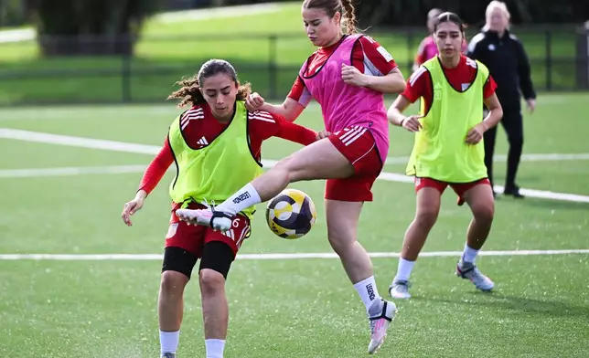 Afghan soccer players Mona Amini, left, and Sosan Mohammadi compete for the ball during a training session in Auckland, New Zealand, Tuesday, June 2, 2026. (Andrew Cornaga/Photosport via AP)