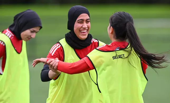 Afghan women's soccer player Khursand Azizi, center, reacts with teammates during a training session in Auckland, New Zealand, Tuesday, June 2, 2026. (Andrew Cornaga/Photosport via AP)