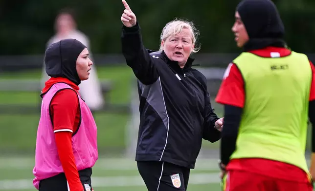 Afghan women's soccer team head coach Pauline Hamill, center, gestures to players during a training session in Auckland, New Zealand, Tuesday, June 2, 2026. (Andrew Cornaga/Photosport via AP)