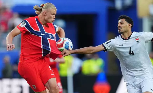 Iraq's Zaid Tahseen, right, grabs Norway's Erling Haaland during the World Cup Group I soccer match between Iraq and Norway in Foxborough, Mass., near Boston, Tuesday, June 16, 2026. (AP Photo/Martin Meissner)