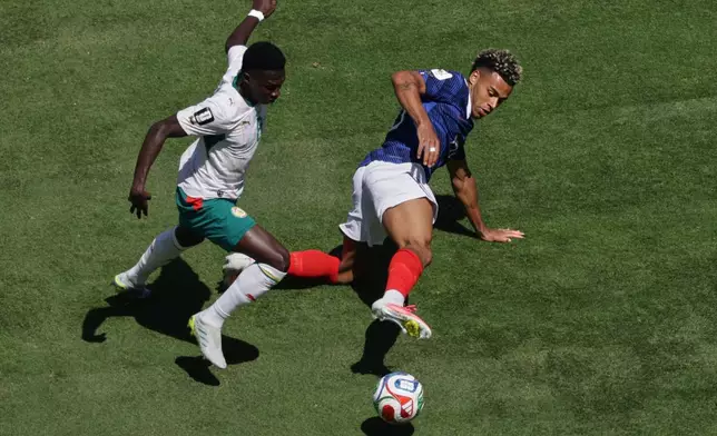 Senegal's Lamine Camara, left, and France's Desire Doue fight for the ball during the World Cup Group I soccer match between France and Senegal in East Rutherford, N.J., near New York, Tuesday, June 16, 2026. (AP Photo/Adam Hunger)