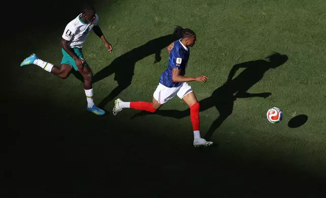 France's Michael Olise (11) moves the ball against Senegal's Habib Diarra (21) during the World Cup Group I soccer match between France and Senegal in East Rutherford, N.J., near New York, Tuesday, June 16, 2026. (AP Photo/Pamela Smith)