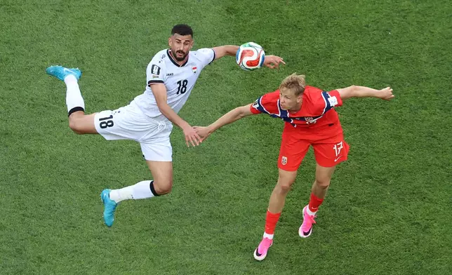 Iraq's Aymen Hussein (18) heads the ball against Norway's Torbjoern Heggem (17) during the World Cup Group I soccer match between Iraq and Norway in Foxborough, Mass., near Boston, Tuesday, June 16, 2026. (AP Photo/Mark Stockwell)