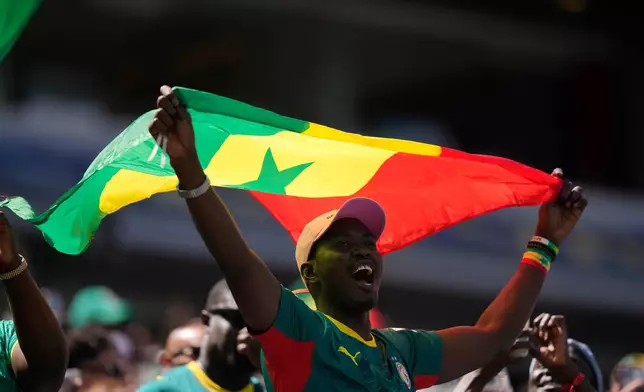 A supporter of Senegal cheers before the start of the World Cup Group I soccer match between France and Senegal in East Rutherford, N.J., near New York, Tuesday, June 16, 2026. (AP Photo/Frank Franklin II)