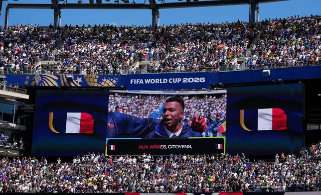 France's Kylian Mbappe is seen on the screen as he sings the national anthem before for the start of the World Cup Group I soccer match between France and Senegal in East Rutherford, N.J., near New York, Tuesday, June 16, 2026. (AP Photo/Frank Franklin II)