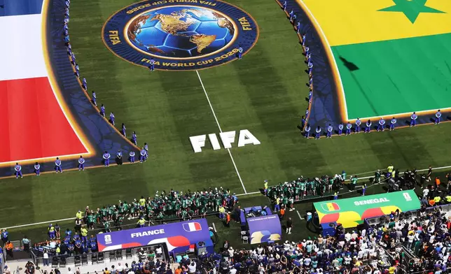 Photographers line up on the sidelines during the World Cup Group I soccer match between France and Senegal in East Rutherford, N.J., near New York, Tuesday, June 16, 2026. (AP Photo/Pamela Smith)