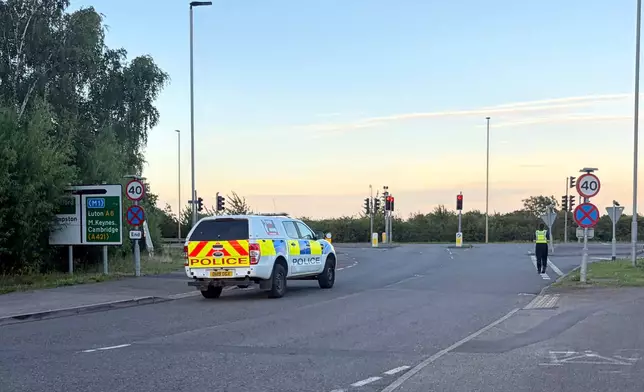 Police close a road in Bedford, England, after a train from Corby to London St. Pancras and another from Nottingham to London St. Pancras, collided on Friday June 19, 2026. (Jordan Reynolds/PA Wire/PA via AP)