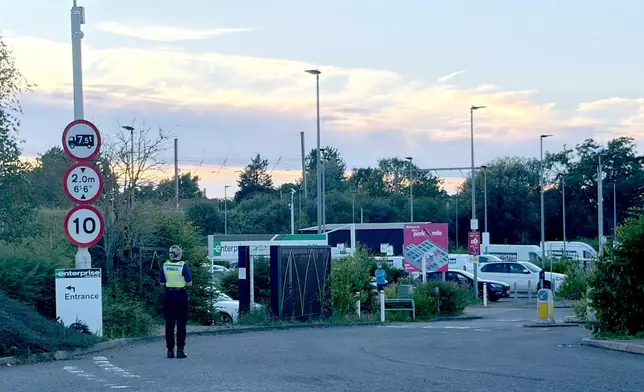 Police at Progress Park in Bedford, England, where families will pick up loved ones, after a train from Corby to London St. Pancras and another from Nottingham to London St. Pancras, collided on Friday June 19, 2026. (Jordan Reynolds/PA Wire/PA via AP)