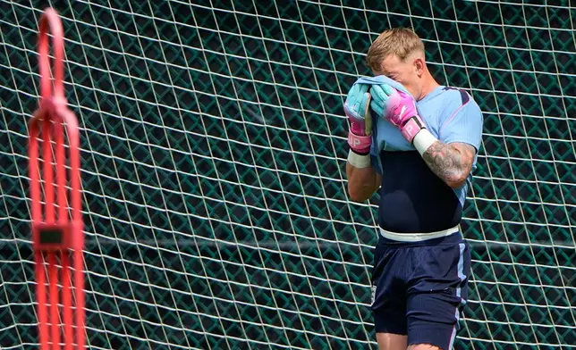 England goalkeeper Jordan Pickford wipes away sweat as he trains for the World Cup soccer tournament Friday, June 26, 2026, in Kansas City, Mo. (AP Photo/Charlie Riedel)