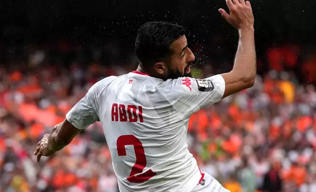 Sweat flies from the head of Tunisia's Ali Abdi (2) after heading the ball during the World Cup Group F soccer match between Tunisia and the Netherlands in Kansas City, Mo., Thursday, June 25, 2026. (AP Photo/Charlie Riedel)
