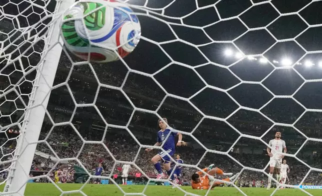 Japan's Junya Ito (14) scores their third goal past Tunisia goalkeeper Aymen Dahmen (16) during the World Cup Group F soccer match between Tunisia and Japan in Guadalupe, near Monterrey, Mexico, Saturday, June 20, 2026. (AP Photo/Dolores Ochoa)