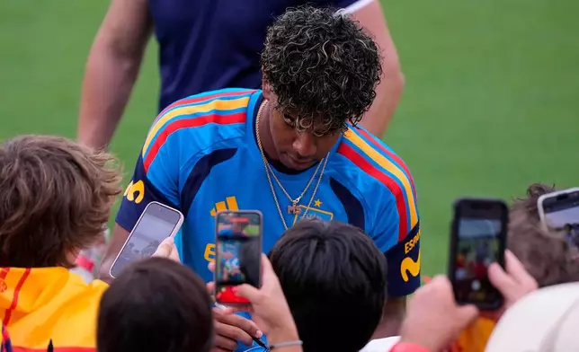 Spain's Lamine Yamal gives autographs during a training session, Saturday, June 6, 2026, in Chattanooga, Tenn., ahead of the World Cup soccer tournament. (AP Photo/Mike Stewart)