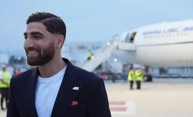 Iran's Alireza Jahanbakhsh smiles as he arrives with his teammates for the World Cup soccer tournament in Tijuana, Mexico, Sunday, June 7, 2026. (AP Photo/Gregory Bull)