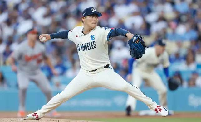 Los Angeles Dodgers starting pitcher Yoshinobu Yamamoto (18) throws during the first inning of a baseball game against the Baltimore Orioles, Saturday, June 20, 2026, in Los Angeles. (AP Photo/Caroline Brehman)