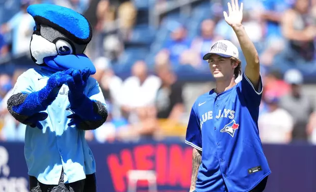 Gavin McKenna, first round pick for the Toronto Maple Leafs and first overall pick of the 2026 NHL draft, arrives to throw the ceremonial first pitch prior to the baseball game between the Toronto Blue Jays and the Texas Rangers, in Toronto, Saturday, June 27, 2026. (Nathan Denette /The Canadian Press via AP)