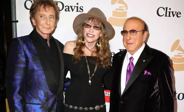 FILE - Barry Manilow, from left, Carly Simon and Clive Davis arrive at the 2016 Clive Davis Pre-Grammy Gala in Beverly Hills, Calif., on Feb. 14, 2016. (Photo by John Salangsang/Invision/AP, File)