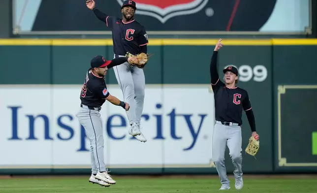 Cleveland Guardians left fielder Steven Kwan, right fielder Kahlil Watson and center fielder Petey Halpin celebrate after a baseball game against the Houston Astros, Saturday, June 20, 2026, in Houston. (AP Photo/Kevin M. Cox)