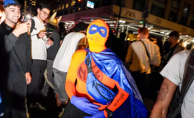 New York Knicks fans celebrate outside of a watch party in Bryant Park for Game 3 of the NBA Finals basketball series between the Knicks and the San Antonio Spurs, Monday, June 8, 2026, in New York. (AP Photo/Ryan Murphy)