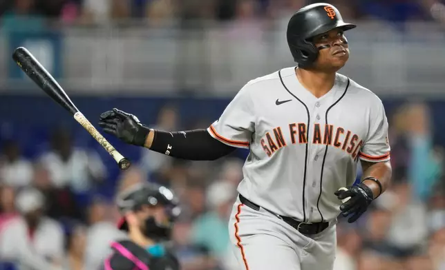 San Francisco Giants' Rafael Devers watches after hitting a solo home run during the sixth inning of a baseball game against the Miami Marlins, Friday, June 19, 2026, in Miami. (AP Photo/Lynne Sladky)
