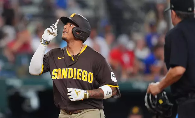 San Diego Padres' Manny Machado points up as he runs the bases after hitting a home run during the 10th inning of a baseball game against the Texas Rangers, Saturday, June 20, 2026, in Arlington, Texas. (AP Photo/LM Otero)