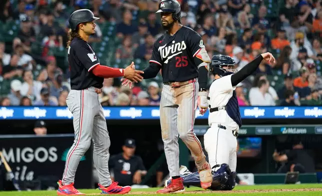Minnesota Twins' Byron Buxton, right, celebrates his three-run home run with Austin Martin, left, during the fifth inning of a baseball game Wednesday, June 10, 2026, in Detroit. (AP Photo/Paul Sancya)