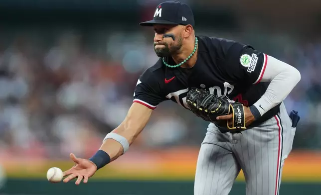 Minnesota Twins first baseman Royce Lewis throws back to first base for an out on a Detroit Tigers' Colt Keith ground ball during the fourth inning of a baseball game Wednesday, June 10, 2026, in Detroit. (AP Photo/Paul Sancya)