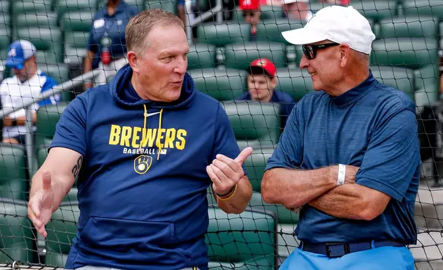 Milwaukee Brewers manager Pat Murphy, left, speaks with his former Florida Atlantic University baseball coach Steve Traylor, right, before the Brewers face the Atlanta Braves in a baseball game, Saturday, June 20, 2026, in Atlanta. (AP Photo/Erik S. Lesser)