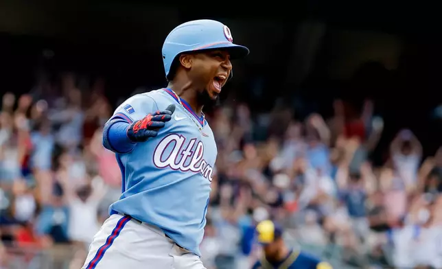 Atlanta Braves' Ozzie Albies celebrates after hitting the winning two-run home run against the Milwaukee Brewers during the ninth inning of a baseball game, Saturday, June 20, 2026, in Atlanta. (AP Photo/Erik S. Lesser)