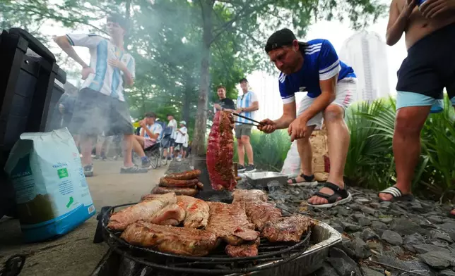 Argentina supporters grill during a rally ahead of their team's World Cup Group J soccer match against Austria, Sunday, June 21, 2026, in Dallas. (AP Photo/Julio Cortez)