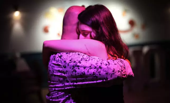 A tattoo in Spanish reading, "There is no law," decorates the arm of a woman dancing during a tango milonga session at Soho Tangoport in Istanbul, Turkey, Thursday, Jan. 29, 2026. (AP Photo/Francisco Seco)