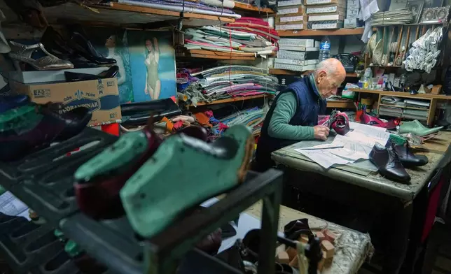 Dance shoe craftsman Ercan Umay works at his workshop in Istanbul, Turkey, Tuesday, Jan. 20, 2026. (AP Photo/Francisco Seco)