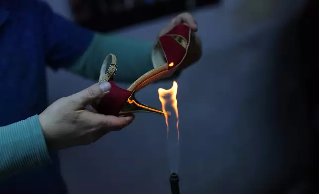 An employee works on crafting tango dance shoes at Necmi Usta's workshop in Istanbul. (AP Photo/Francisco Seco)