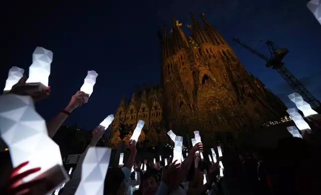 Faithful attend the the inauguration ceremony of the Tower of Jesus Christ at the Basilica of the Sagrada Familia in Barcelona, Spain, Wednesday, June 10, 2026 (AP Photo/Alessandra Tarantino)