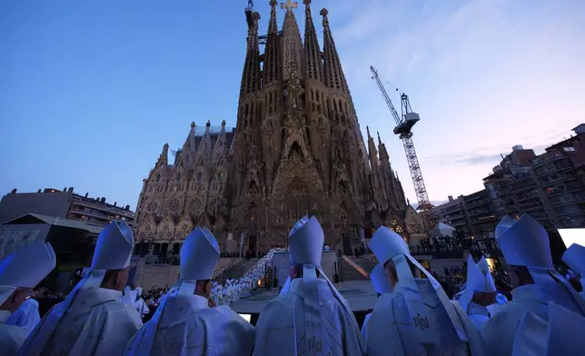 Priests attend the inauguration of the Tower of Jesus Christ at the Basilica of the Sagrada FamÌlia in Barcelona, Spain, Wednesday, June 10, 2026. (AP Photo/Emilio Morenatti)