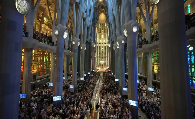 Pope Leo XIV, bottom, walks in procession to celebrate a mass in the Basilica of the Sagrada Familia in Barcelona, Spain, Wednesday, June 10, 2026 (AP Photo/Alessandra Tarantino)