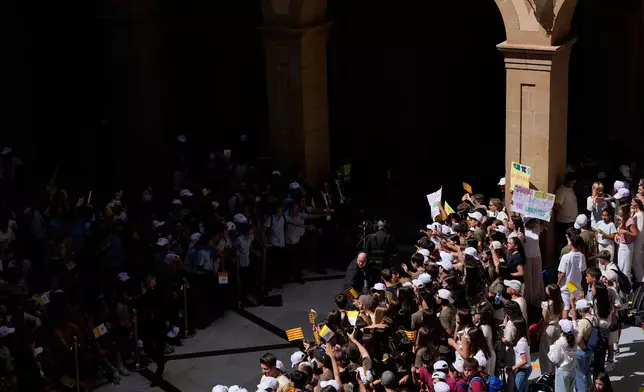 People wait for the arrival of Pope Leo XIV to lead a rosary at the Abbey of Our Lady of Montserrat, in Montserrat, Spain, Wednesday, June 10, 2026. (AP Photo/Alessandra Tarantino)