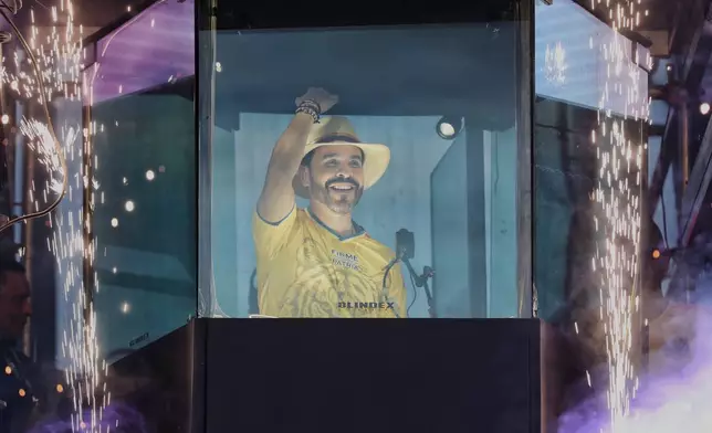 Presidential candidate Abelardo de la Espriella stands before supporters from inside a bulletproof booth during his campaign rally in Buga, Colombia, Sunday, June 14, 2026. (AP Photo/Santiago Saldarriaga)